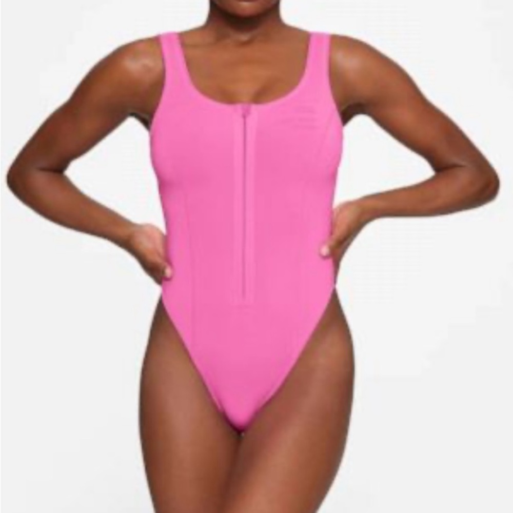 Used SKIMS surf swimsuit in XS hot pink.